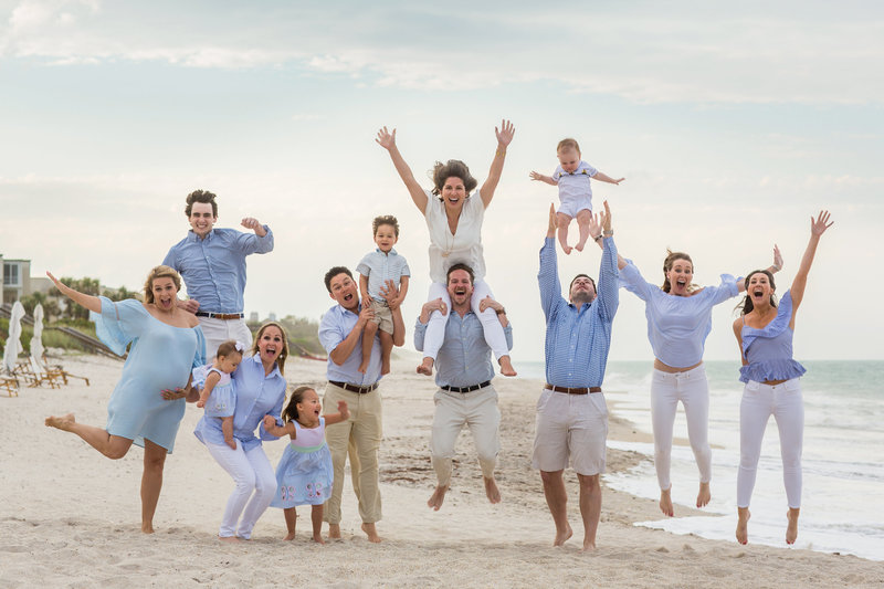 Fun family photo jumping on the beach