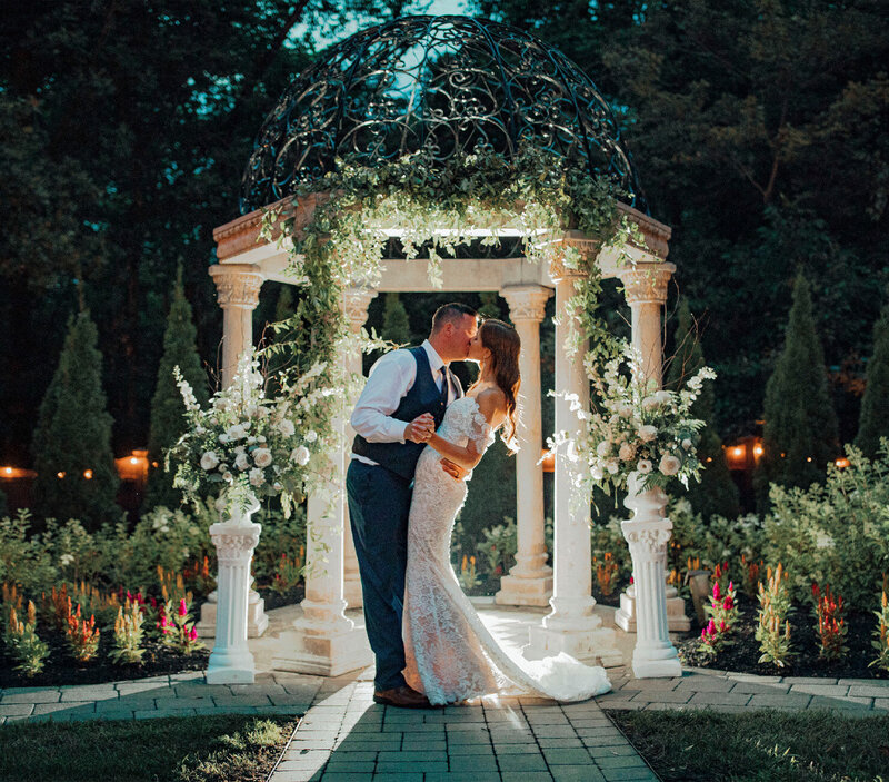 The Hamilton Manor Wedding | Bride and Groom Kiss Under Ivy-Covered Gazebo with Twinkle Lights | Hamilton Township, New Jersey