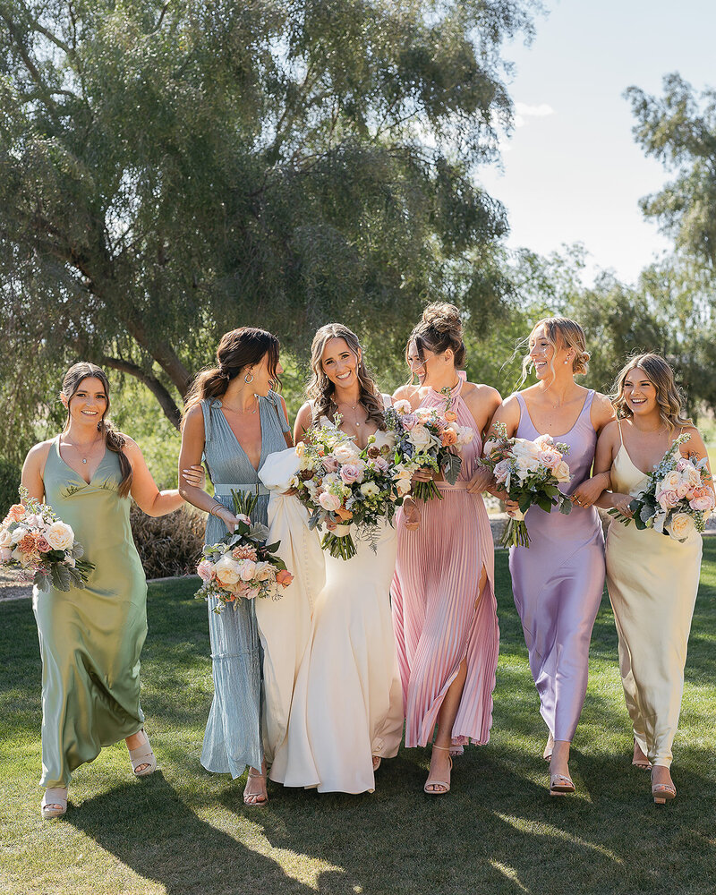 Bridal party wearing pastel bridesmaid dresses at outdoor Arizona wedding