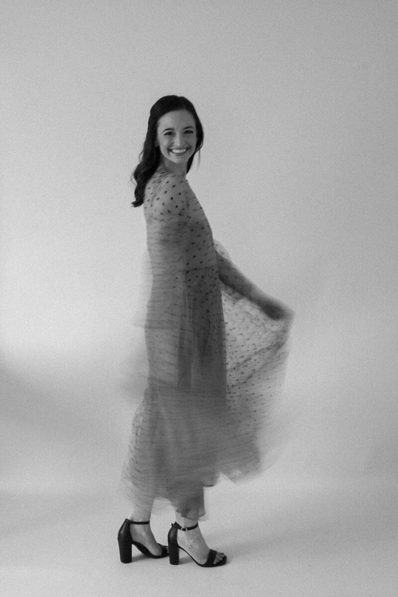 blurred black and white photo of woman in a polka dot tulle dress