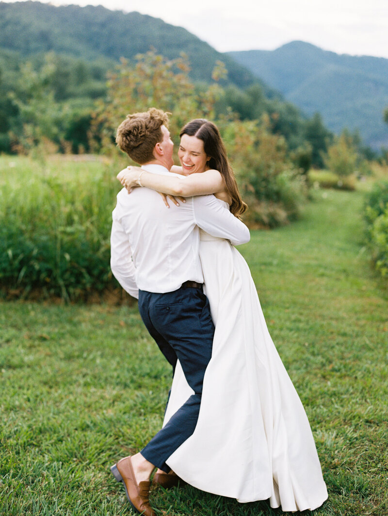The bride and groom embrace after their wedding at Paint Rock Farm, and venue with accommodations in North Carolina, by destination wedding photographer Megan Lynn of My Sun and Stars Co.