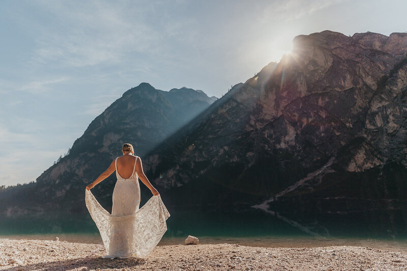 bride poses by a lake