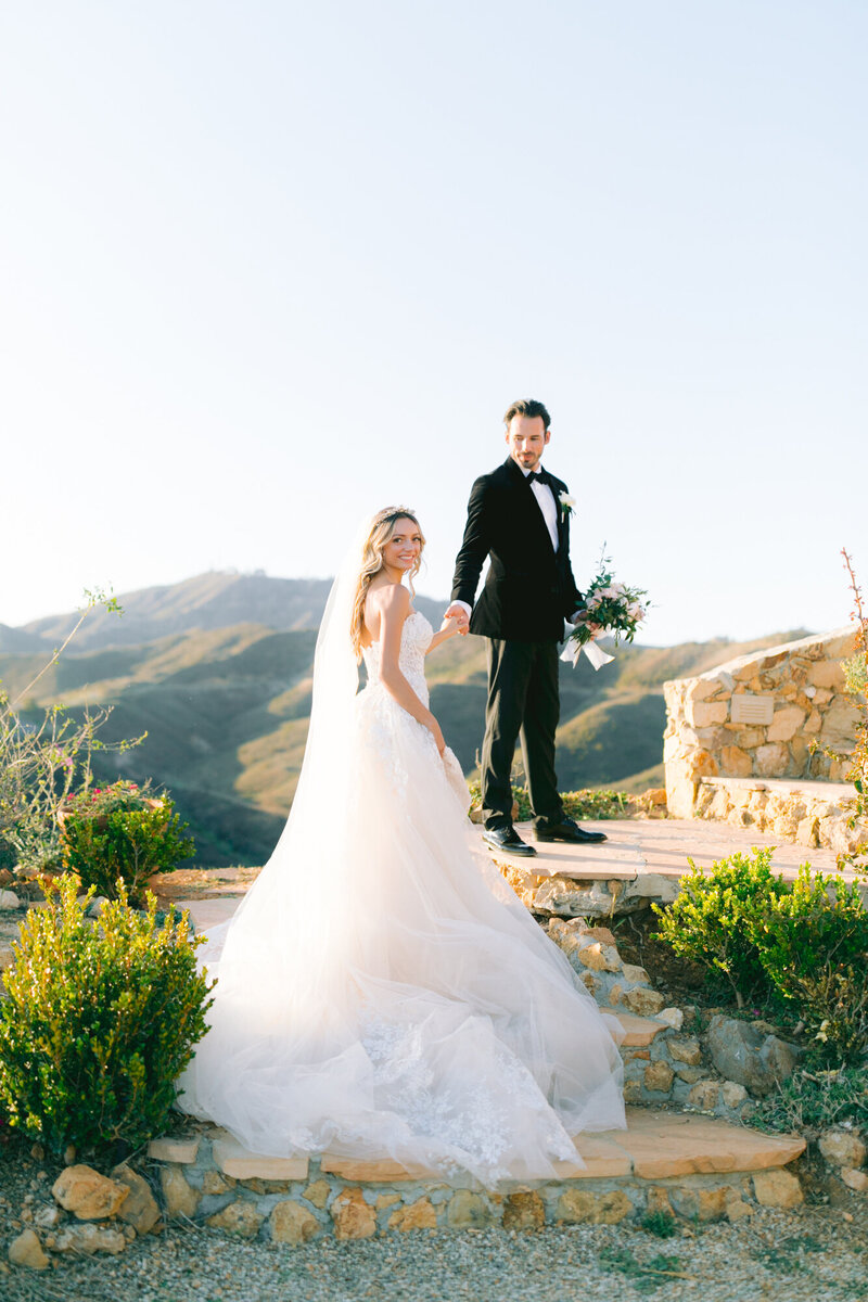 romantic portrait of bride and groom at winery mountain view