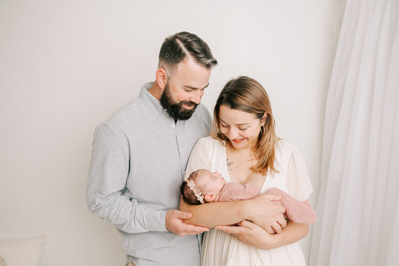 Family of three capturing a sweet moment in the studio