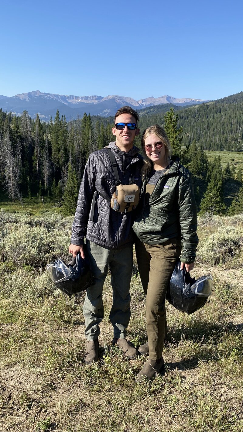 woman and man outdoors with RV helmets
