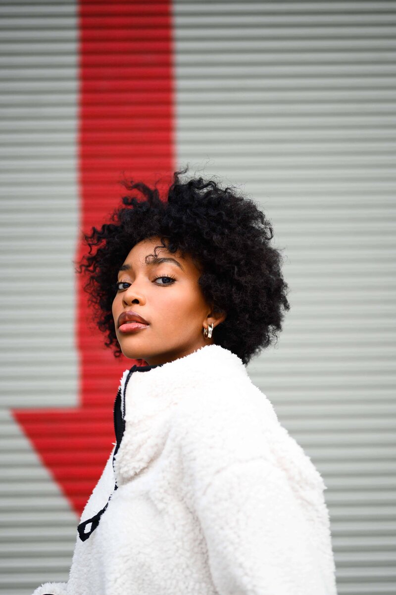 Confident woman in white jacket