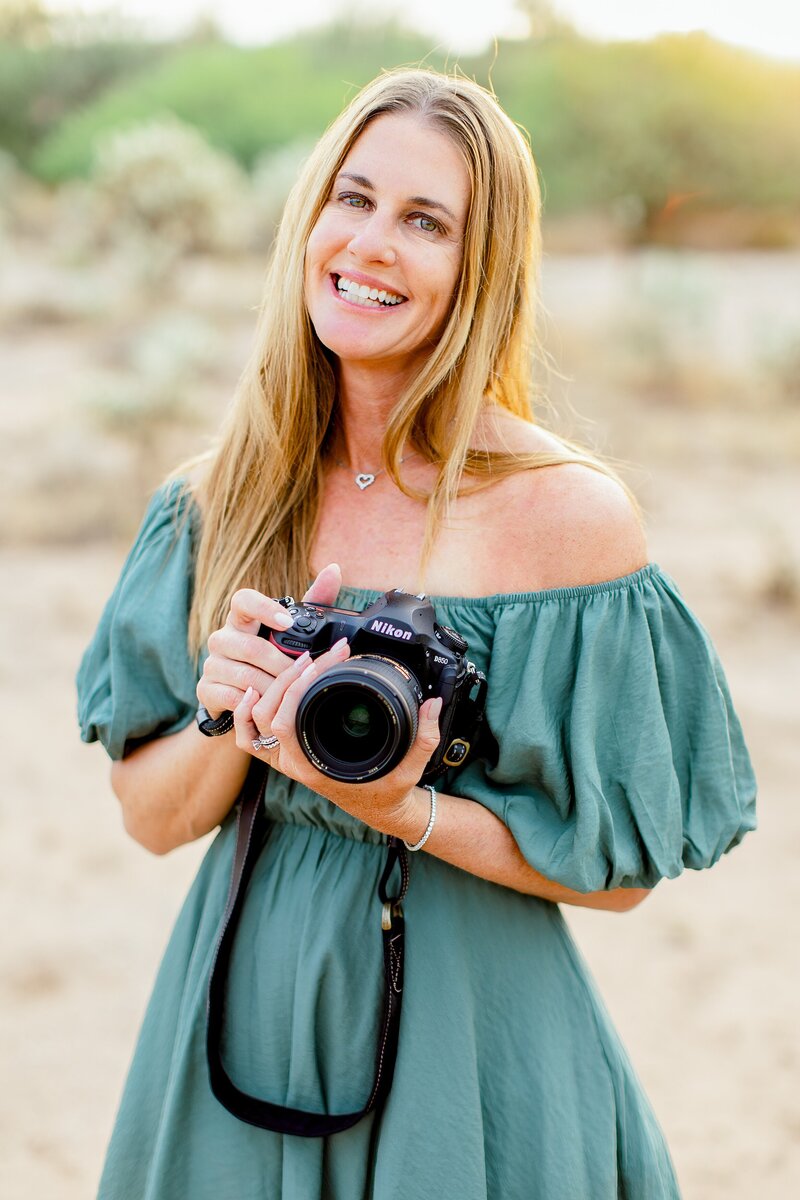 Photographer posing with camera at lost dutchman state park for branding photos