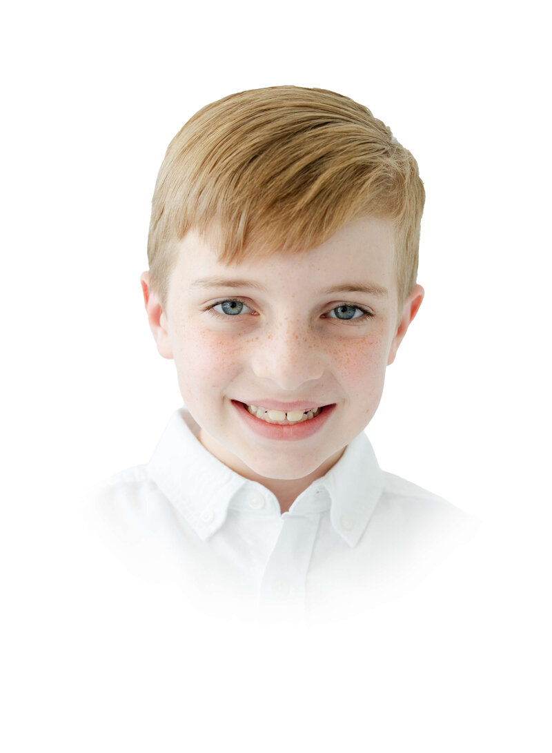 boy posing smiling for heirloom photos in mini model rep program