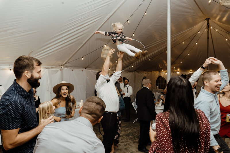 people partying man tossing child in air