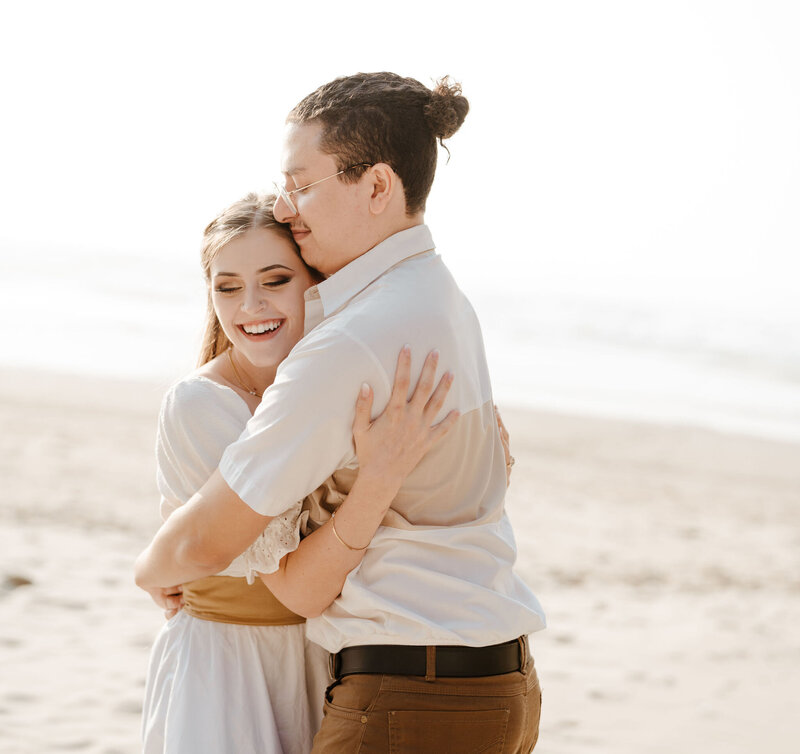 a couple hugging on the beach