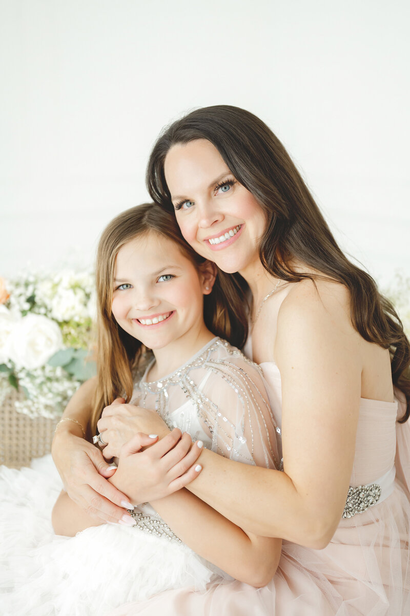 Mother holding daughter floral background motherhood mini sessions