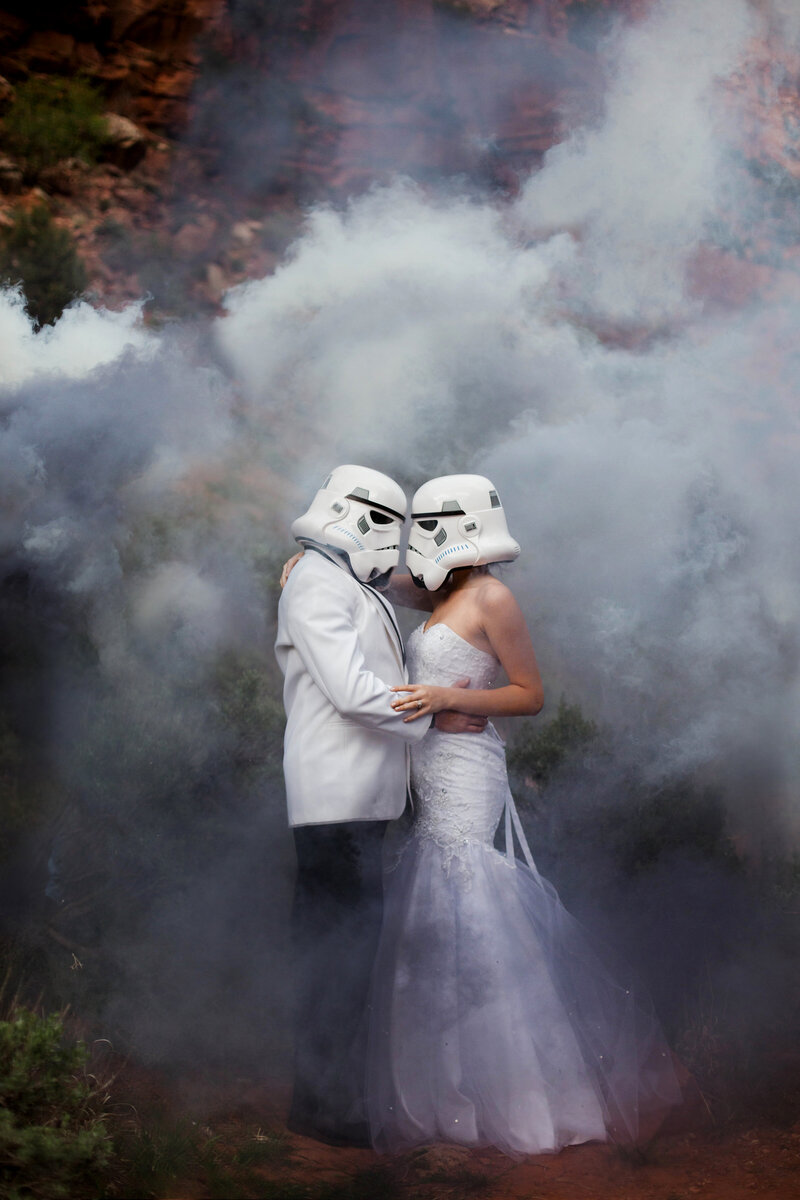 bride and groom hugging wearing storm trooper helmets