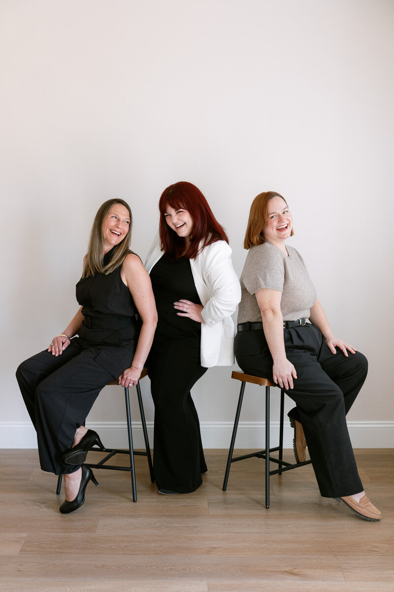 Anna Delores Photography founder, Emily, smiles in a green and navy dress