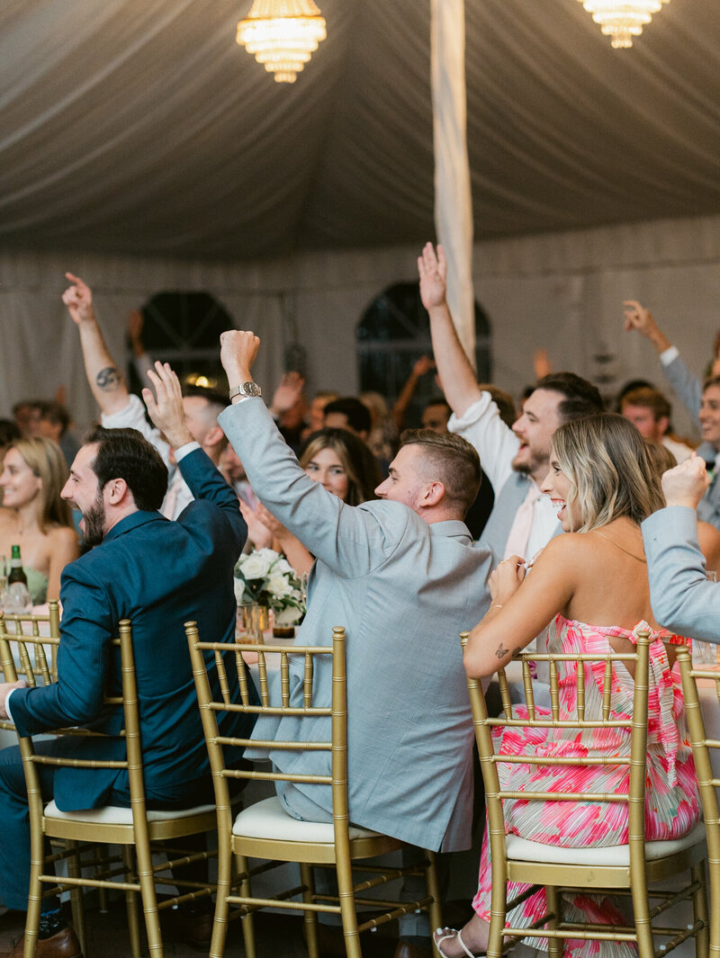 wedding guests raising hands taken by one of the best baltimore wedding photographers, Nicole Simensky