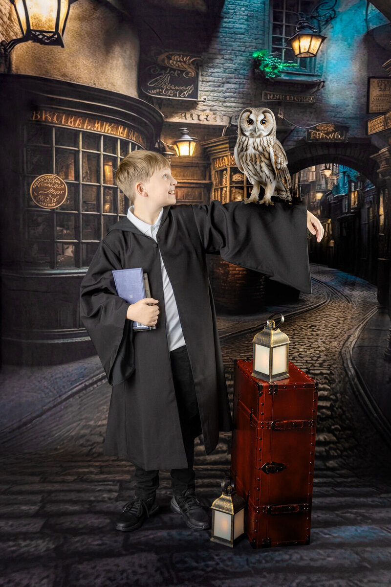 A young boy poses with an owl at the Wizarding School Portrait event in Myrtle Beach, SC