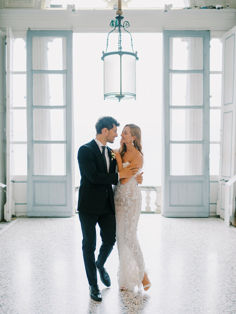 A-bride-and-groom-standing-in-an-ornate-room
