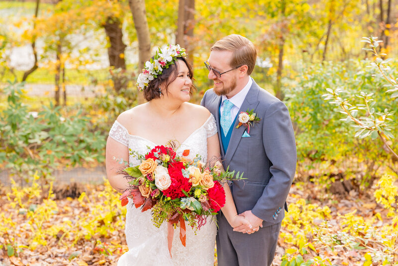 A couple poses for a photo in the gardens of Gramercy Mansion for a fall portrait for Gramercy Mansion Wedding Photographer