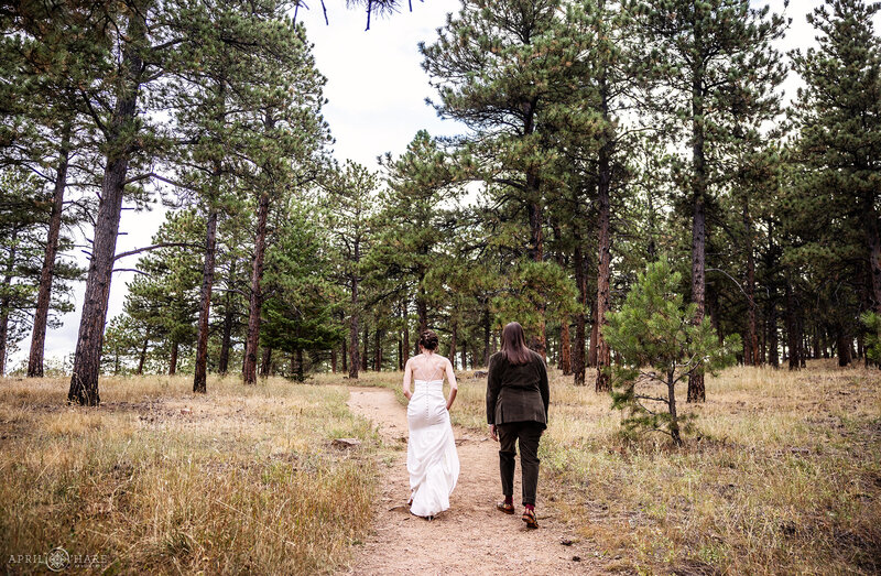 Couple Walks Through the Forest Nature Preserve at their Boettcher Mansion Wedding