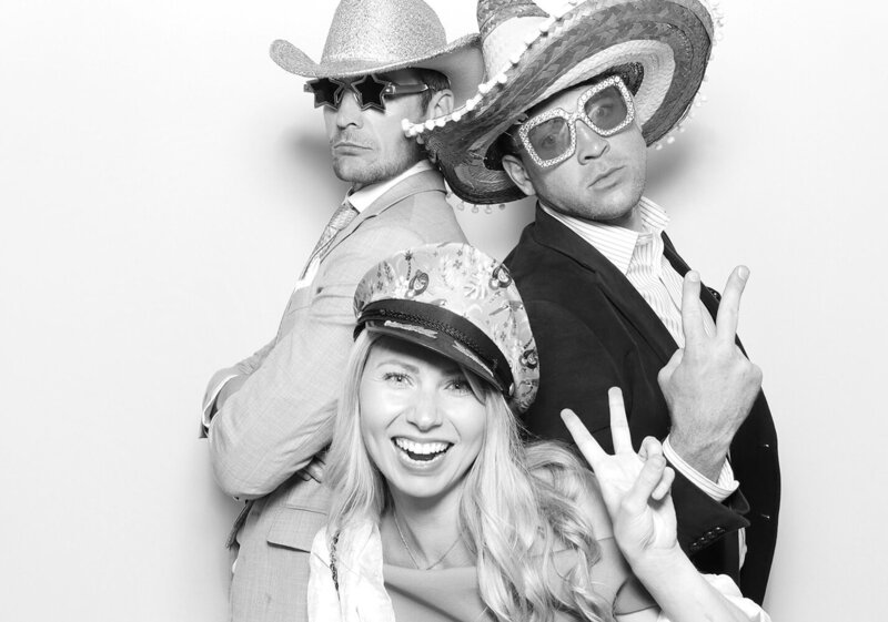 3 guests posing against a white backdrop, during a Corporate event for a Farleigh House photo booth rental 