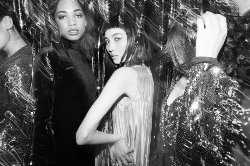 Black and white picture of girls in sparkly clothes at a party