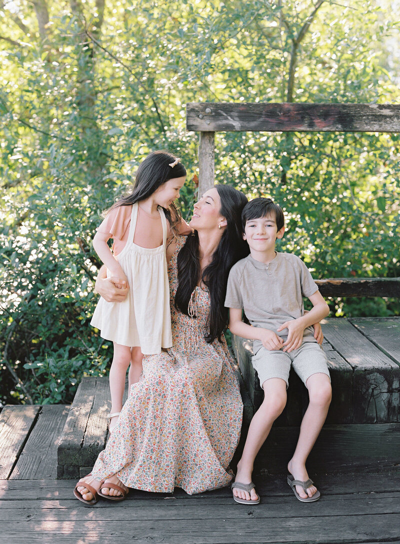 Seattle family photographer Brittany Carvalho in a candid photo with her kids on the dock in summer. 