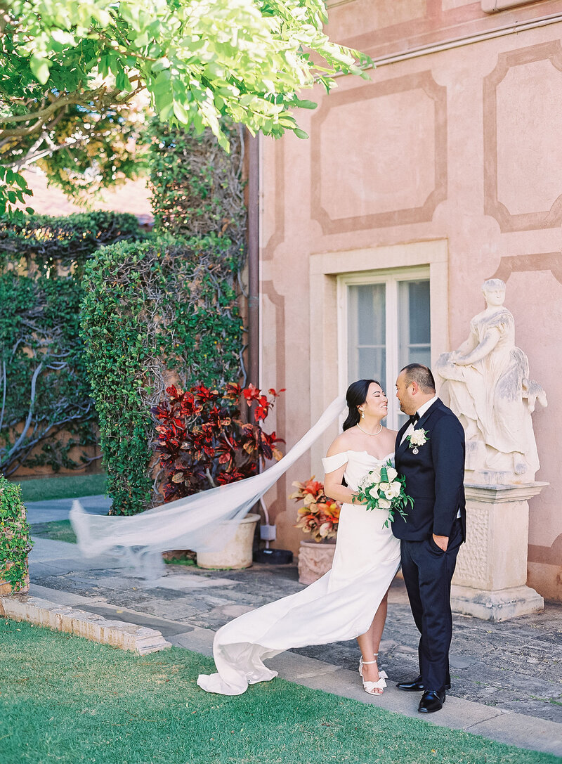 Bride and groom exchanging vows at the historic La Pietra School for Girls in Oahu during their wedding ceremony.