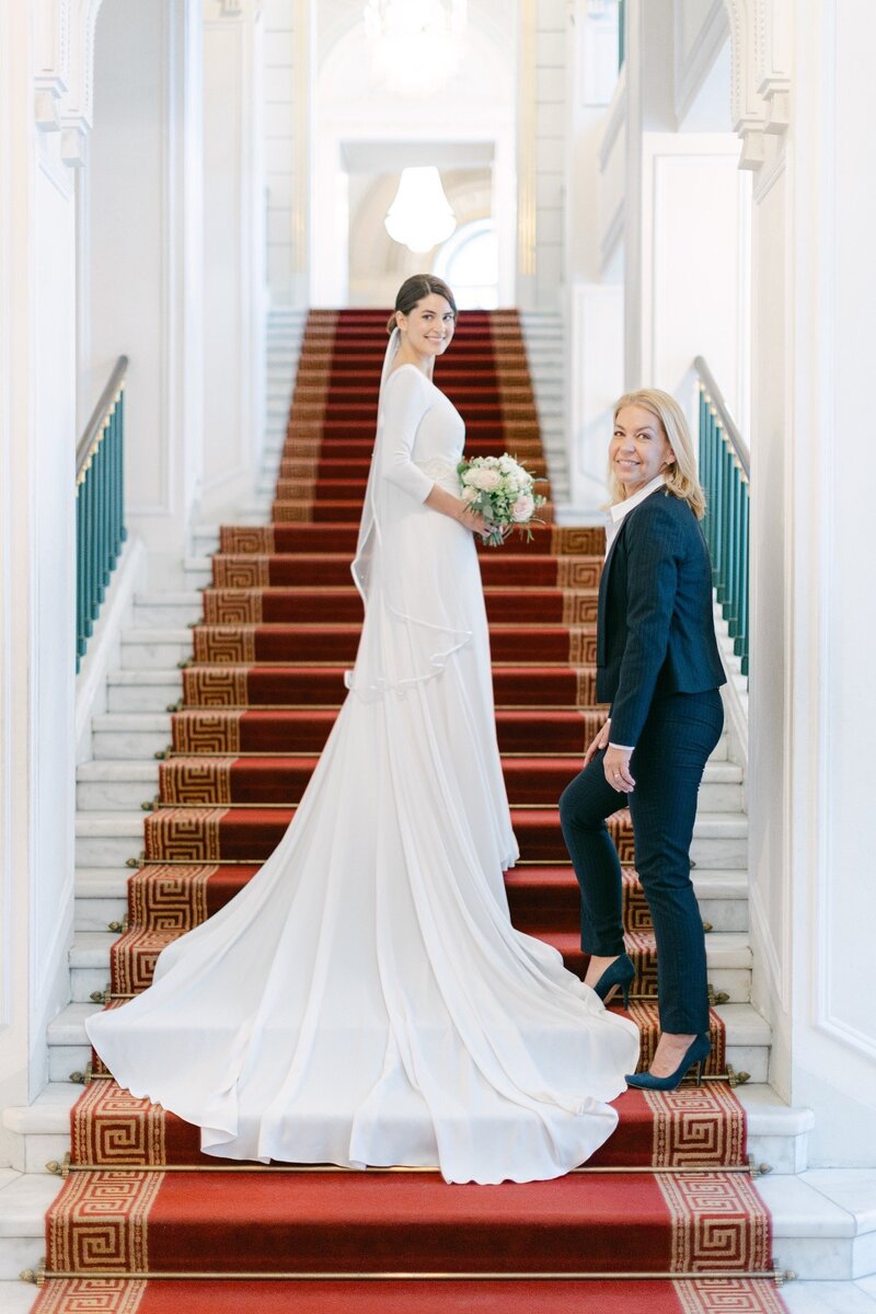 Destination wedding bride standing on the majestic stars together with ECLAT Destination Wedding Team in Vienna