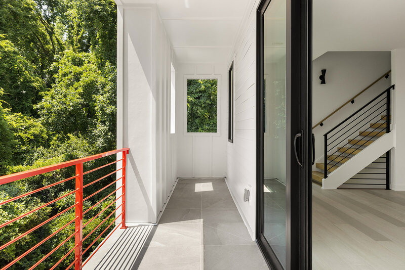 patio off of living room with sliding door and white exterior