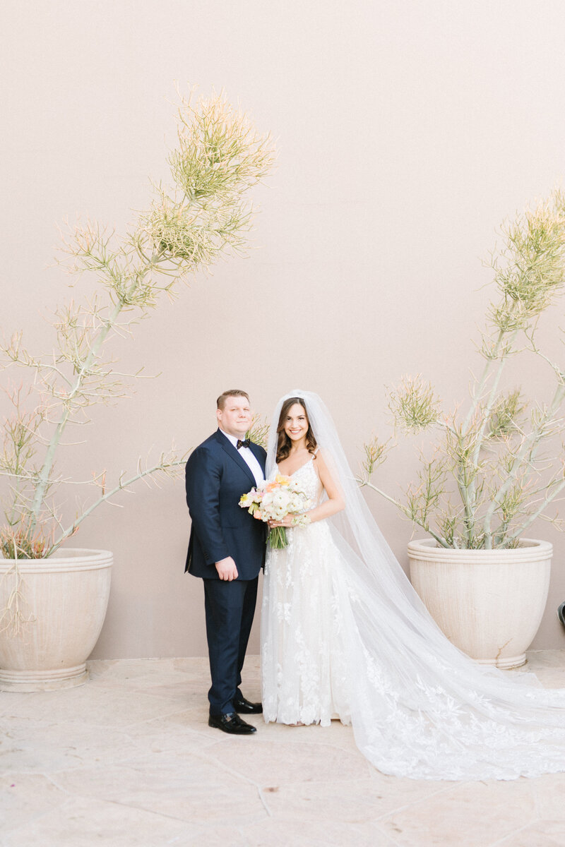 Bride and groom kissing in front of white trolley