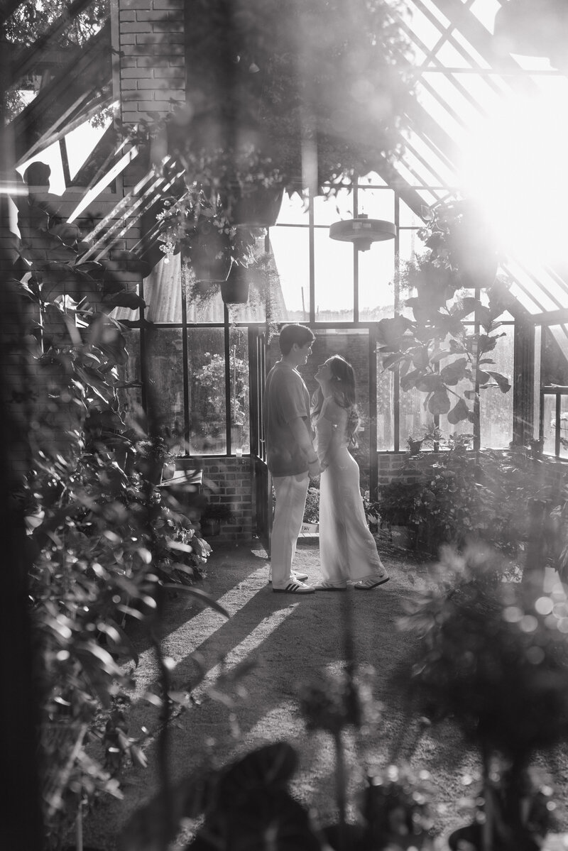 Alabama photographer captures dreamy engagement photos inside vintage bookstore in Athens AL picturing couple reading together on a vintage couch