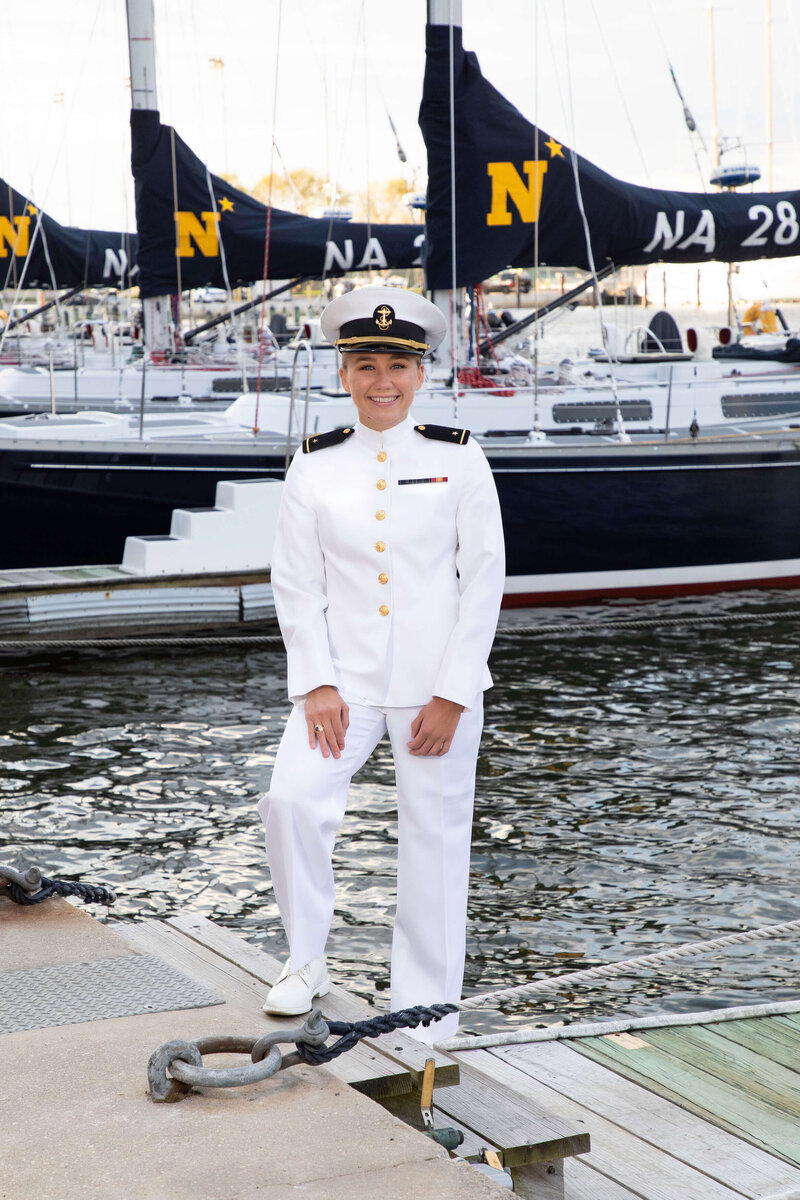 US Naval Academy senior graduation and midshipman portrait on the dock with sailboats in Santee basin by Kelly Eskelsen.