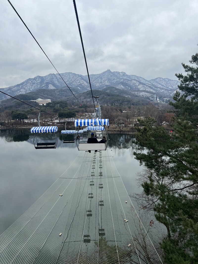 Cable car over a mountain lake in Asia – family adventures abroad captured by Leaving Main Street
