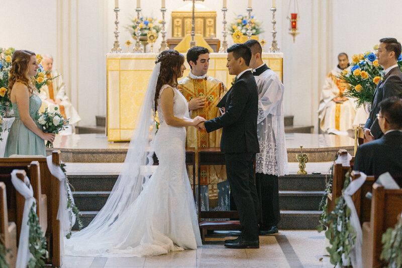 Bride and groom holding hands during wedding ceremony