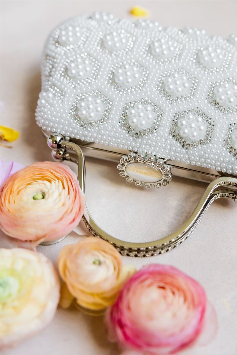 Photo of bride's flatlay details with bright and colorful blooms and a gorgeous invitation suite