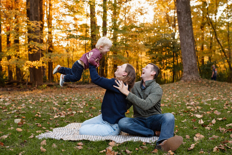A family posing for fall mini sessions in park