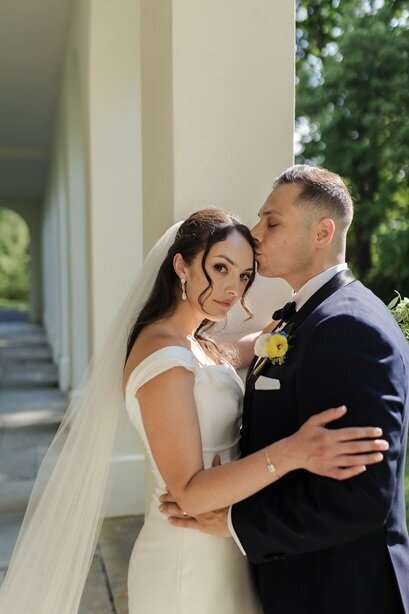 Bride and groom kiss at sunset in an outdoor wedding captured by cinematic videographer in Indianapolis