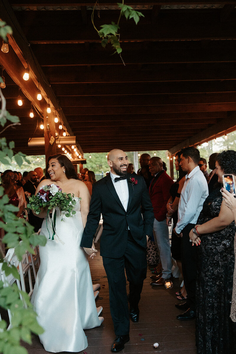 Couple walking back down the isle after their ceremony at Brandermill Country Club