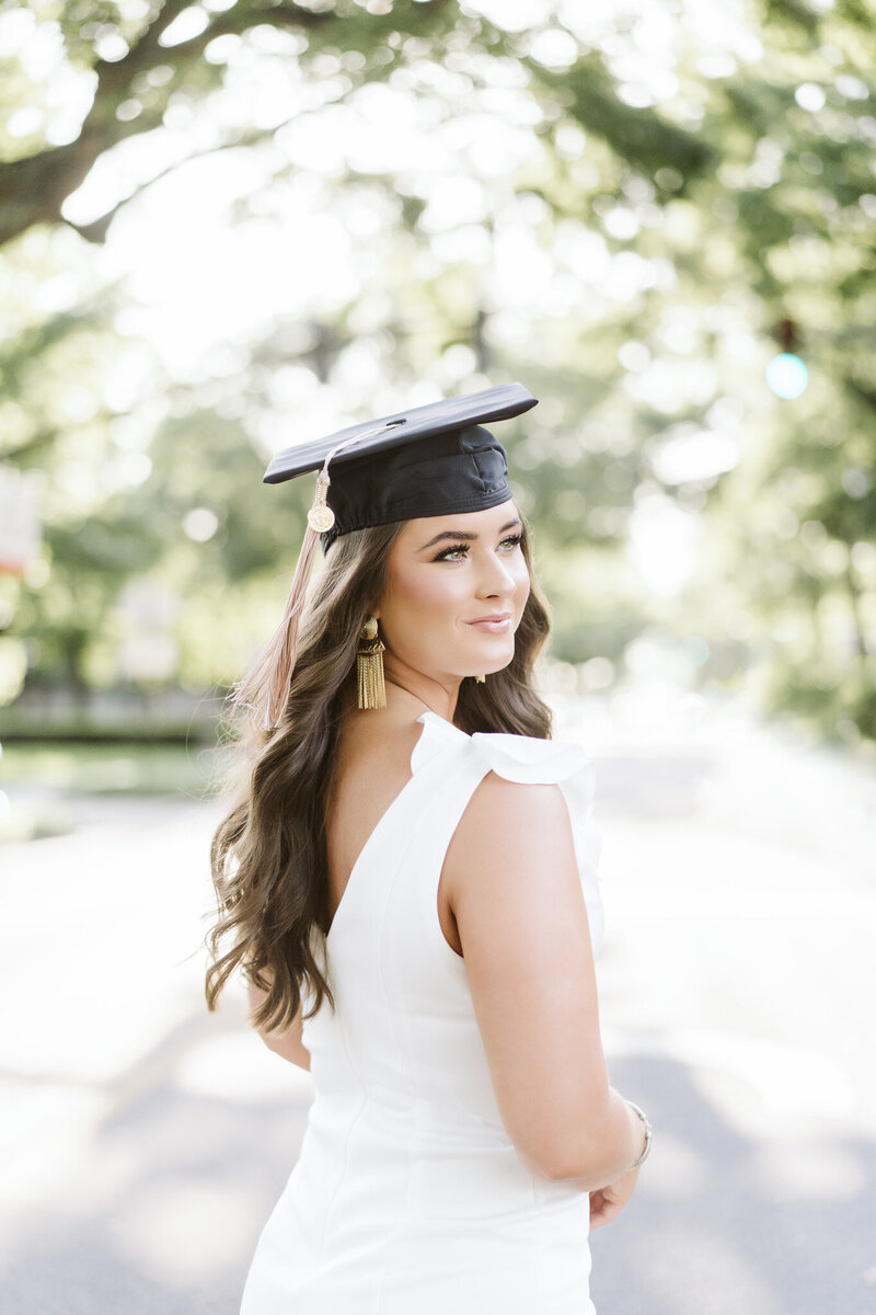 A graduate in her cap standing in University Boulevard