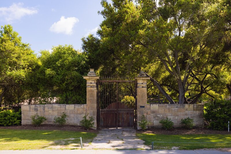 French architecture gates and trees at Vista Valley Country Club in San Diego.