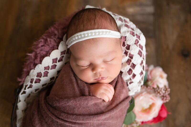 Appleton Wisconsin Newborn Studio Session baby posed in prop with flowers sleeping | Glory Be Photography by Tara Bos
