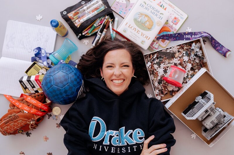 Carrie smiling while wearing a Drake University sweatshirt