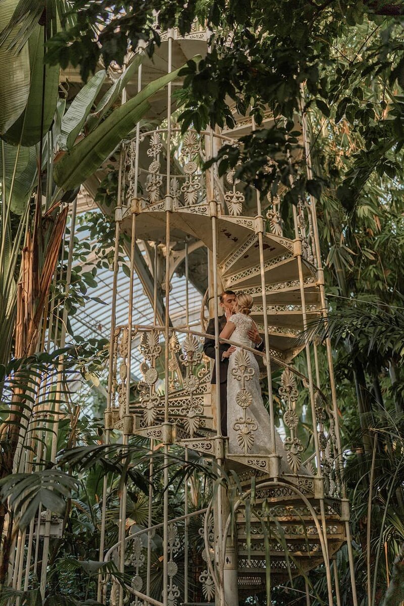 A Gride and Groom on a spiral staircase at Kew Gardens, London