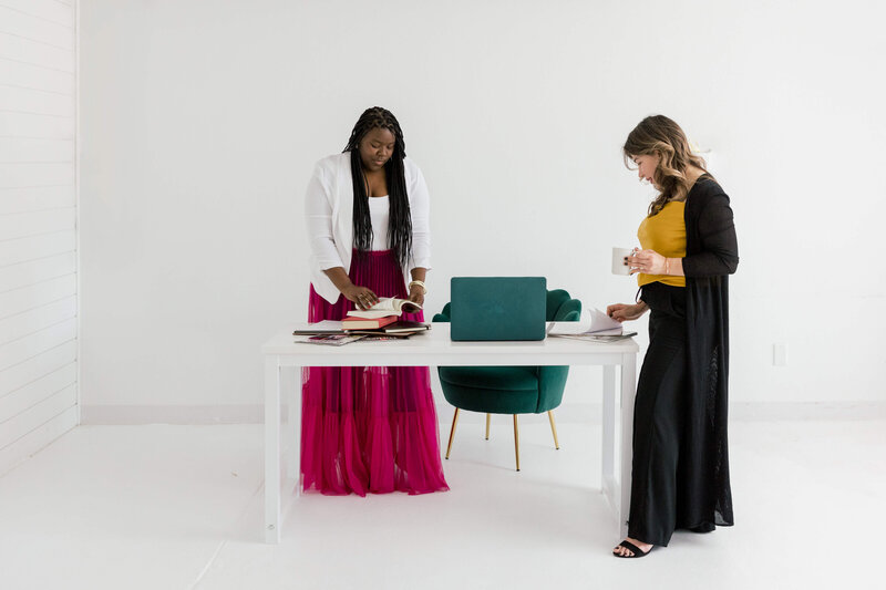 Chessica LaBianca and Nicole Kehoe, co-founders of House of Prodigy, working together at a white desk