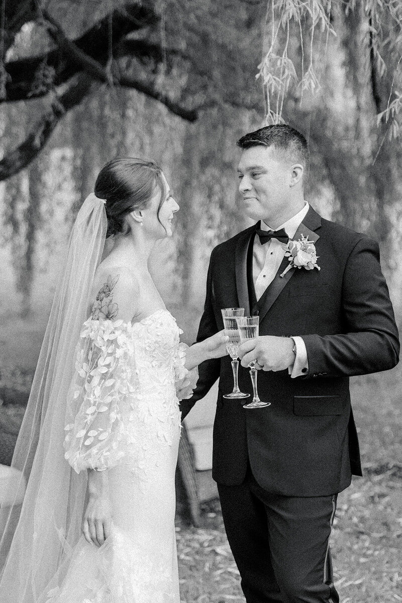 Bride and groom toasting champagne flutes