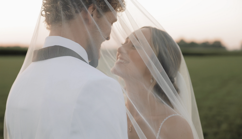 Bride and groom kiss in a field at Sammlung Platz