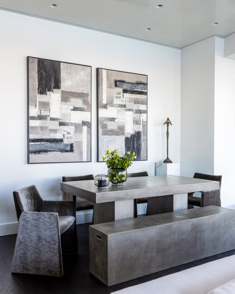 Boston modern dining room featuring a concrete dining table, minimalist decor, and natural light