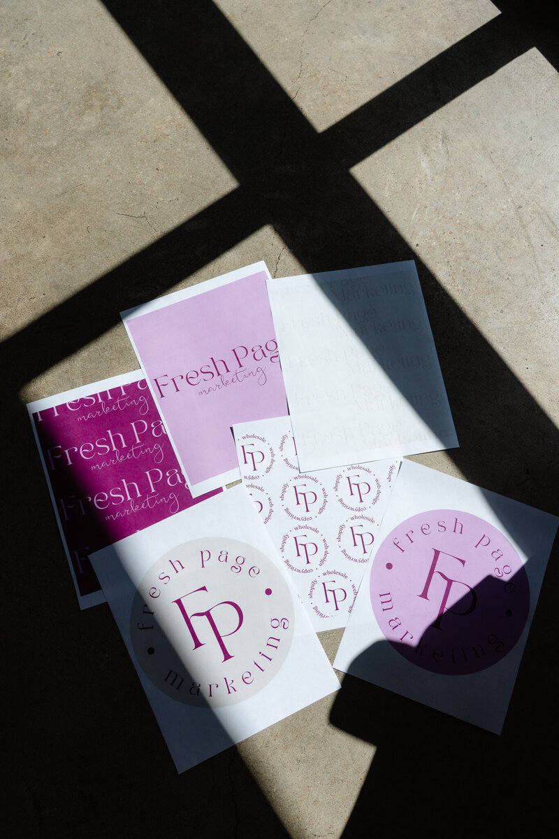 Fresh Page Marketing logo sheets and brand materials in pink and purple, representing ecommerce management, Shopify support, Faire wholesale growth, copywriting, and website design services.