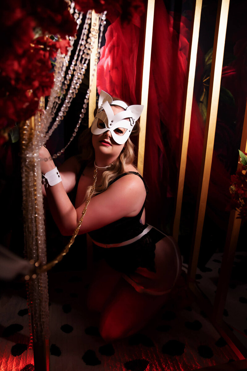 Bold and enticing boudoir image, evoking a sense of luxury and kinkiness with cage and mask and gems in Scottsdale, AZ