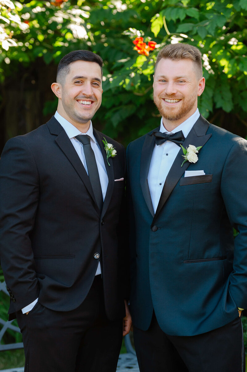a photo of a groom and best man in black tuxedos taken outdoors by Ottawa wedding photographer JEMMAN Photography