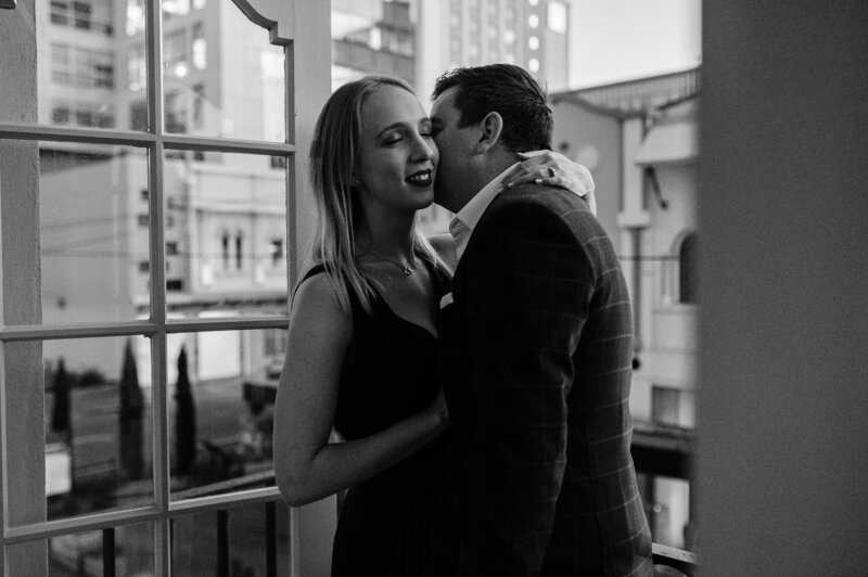 cbd urban couple christchurch engagement wedding black white kiss cheek evening elegant modern new regent gin street
